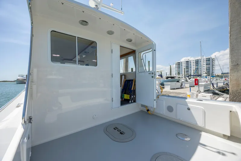 Tomahawk Yacht Photos Pics 2011 Flowers Hardtop boat deck with marina view, featuring modern design and spacious layout.