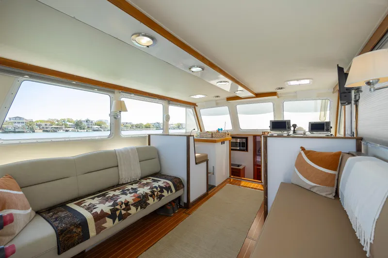 Tomahawk Yacht Photos Pics Luxurious 2011 Flowers Hardtop boat interior with comfortable seating and scenic windows.