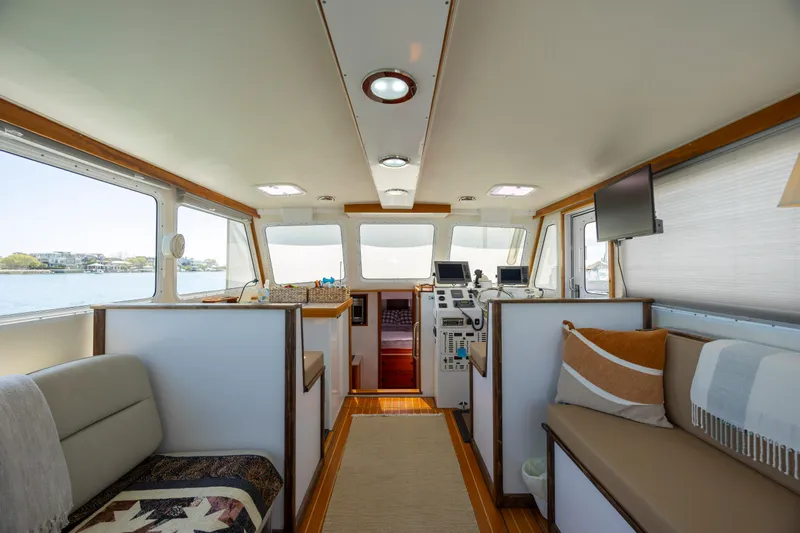 Tomahawk Yacht Photos Pics Interior of 2011 Flowers Hardtop boat, featuring seating and navigation equipment.