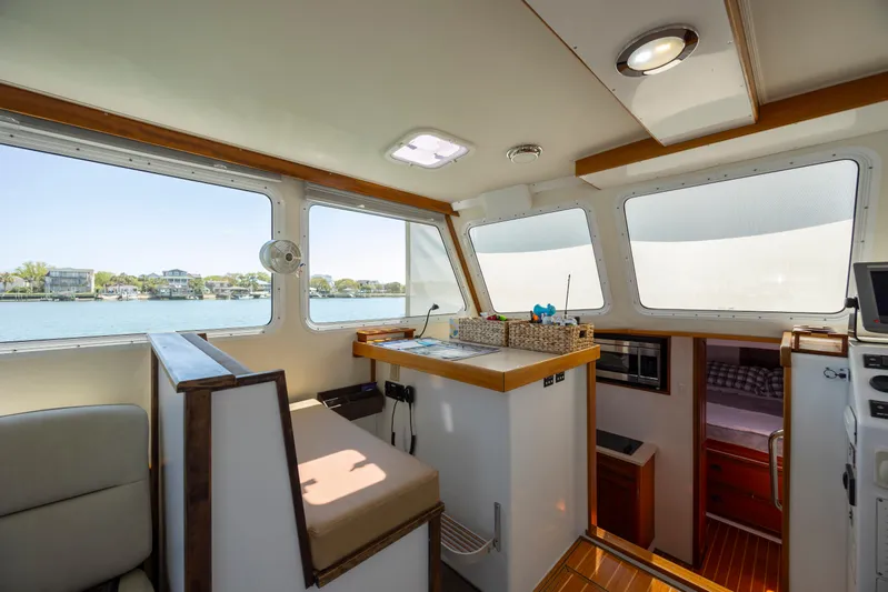Tomahawk Yacht Photos Pics Interior of 2011 Flowers Hardtop boat with seating and windows overlooking water.