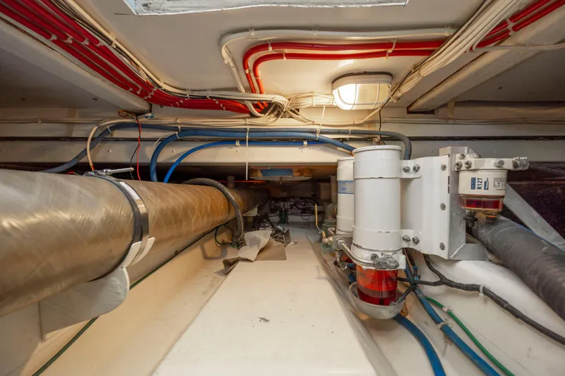 Tomahawk Yacht Photos Pics Engine room with pipes and wiring in a 2011 Flowers Hardtop boat.