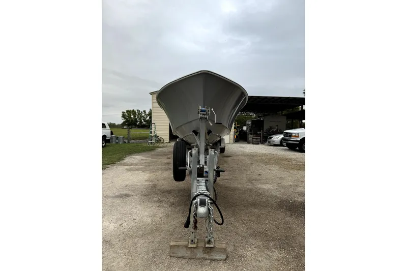  Yacht Photos Pics 2014 Contender 39 ST boat on trailer, parked outdoors on a cloudy day.