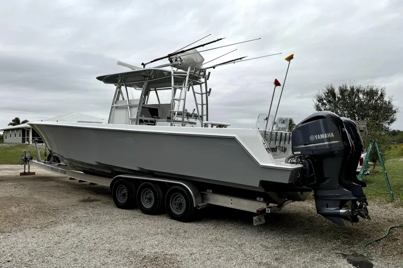  Yacht Photos Pics 2014 Contender 39 ST boat on trailer with Yamaha engines, parked outdoors.