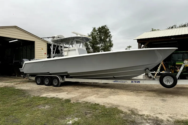  Yacht Photos Pics 2014 Contender 39 ST boat on trailer near storage buildings.