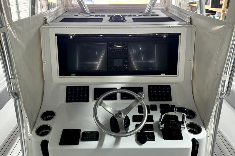  Yacht Photos Pics 2014 Contender 39 ST boat dashboard with steering wheel and electronic controls.