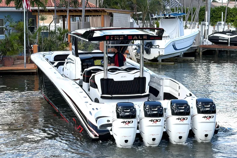 Fire Sale Yacht Photos Pics 2019 MTI V42 boat with five powerful outboard engines docked in a marina.