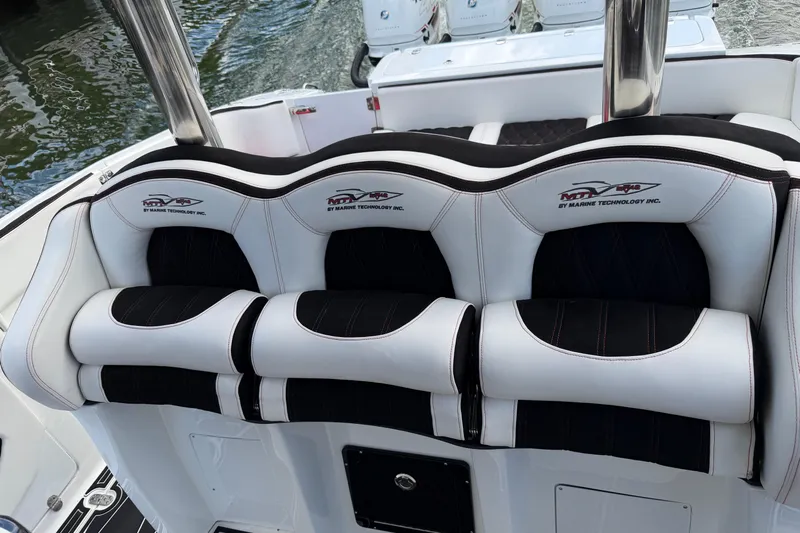 Fire Sale Yacht Photos Pics Luxury seating on a 2019 MTI V42 boat, featuring sleek black and white design.