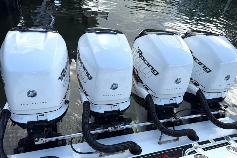Fire Sale Yacht Photos Pics Four powerful outboard motors on a 2019 MTI V42 boat, reflecting on water.