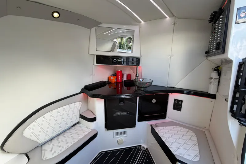 Fire Sale Yacht Photos Pics Interior of 2019 MTI V42 boat with modern seating, counter, and control panel.