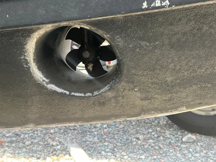  Yacht Photos Pics Close-up of a 2019 Pursuit S 288 Sport boat's bow thruster on gravel.