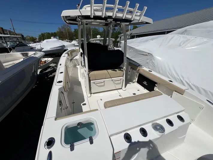  Yacht Photos Pics 2019 Pursuit S 288 Sport boat with spacious deck and seating, docked outdoors.