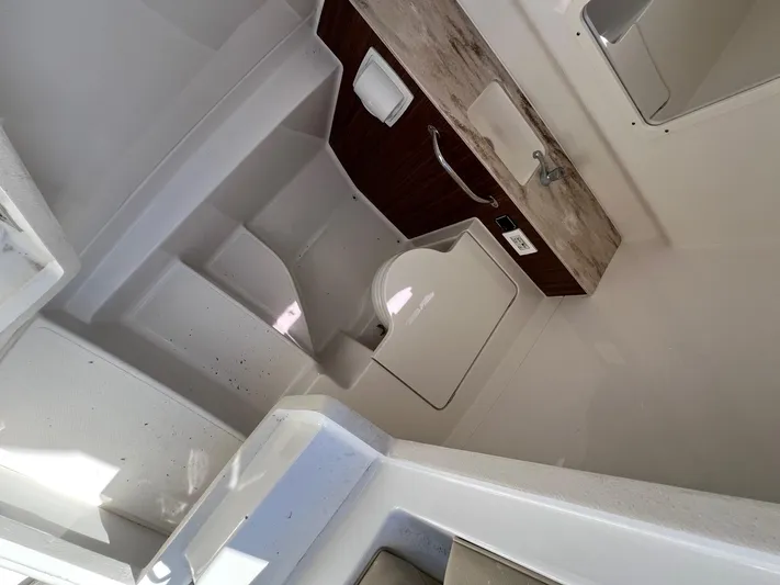  Yacht Photos Pics 2019 Pursuit S 288 Sport boat interior with sink and storage compartments.