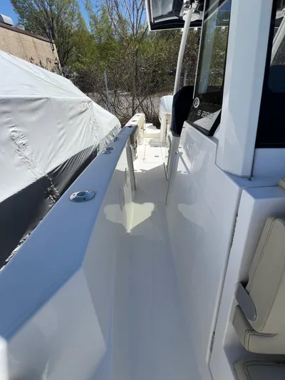  Yacht Photos Pics 2019 Pursuit S 288 Sport boat deck, sleek design, white finish, outdoor setting.