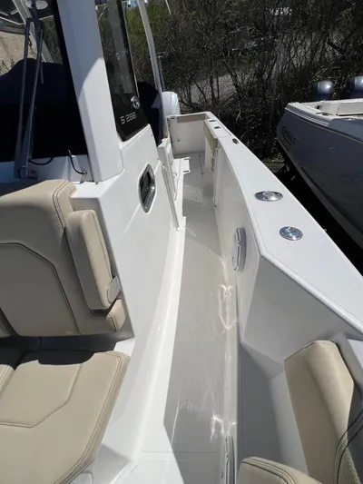  Yacht Photos Pics 2019 Pursuit S 288 Sport boat interior with beige seating and sleek white deck.