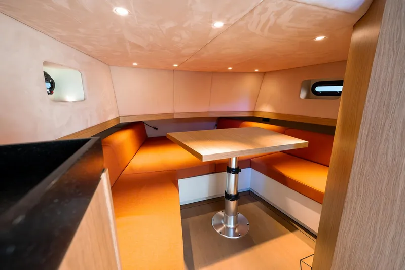 Yacht Photos Pics Cozy interior of 2023 Lekker 44 boat with orange seating and modern table.