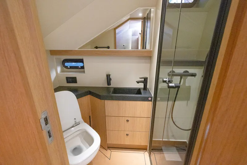  Yacht Photos Pics Modern bathroom in 2023 Lekker 44 yacht with shower, sink, and toilet.