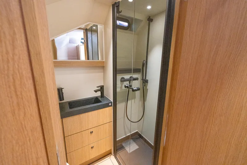  Yacht Photos Pics Modern bathroom in 2023 Lekker 44 yacht with wood accents and glass shower.