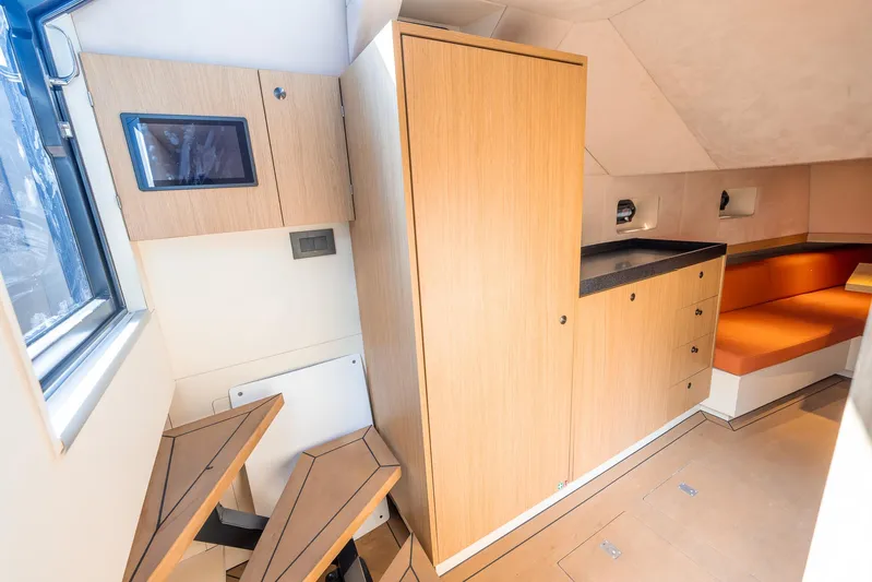  Yacht Photos Pics Modern interior of 2023 Lekker 44 boat with wood cabinetry and seating.