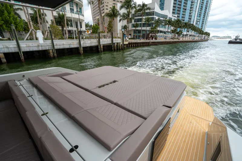  Yacht Photos Pics 2025 De Antonio Yachts D42 Open cruising near urban waterfront with modern buildings.