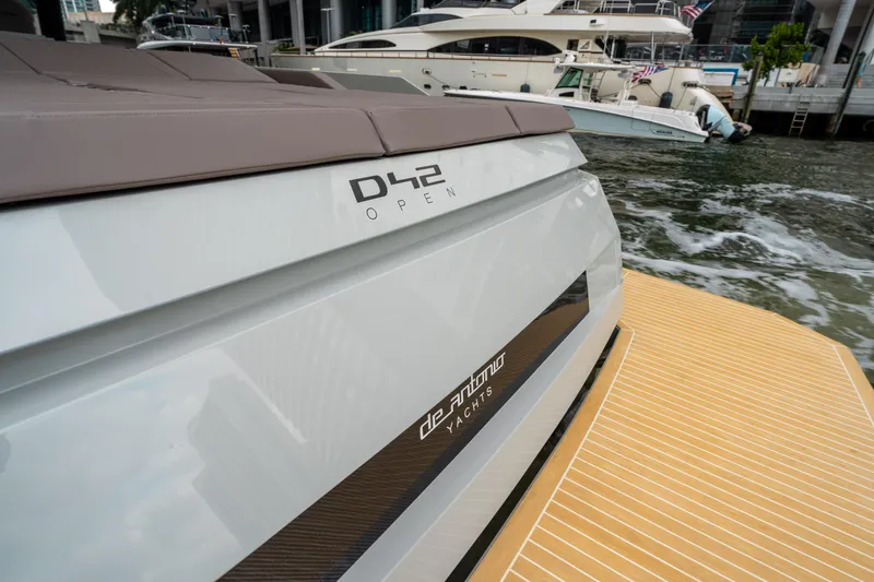  Yacht Photos Pics 2025 De Antonio Yachts D42 Open, sleek design, docked near water.