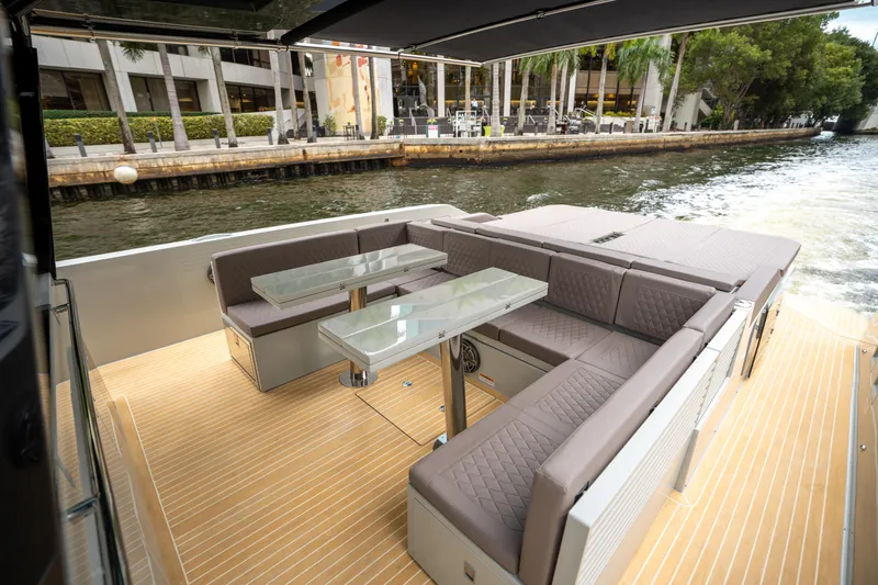  Yacht Photos Pics 2025 De Antonio Yachts D42 Open, featuring a luxurious outdoor seating area with glass tables.