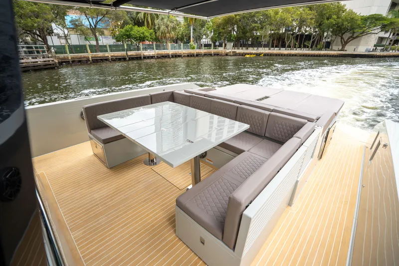  Yacht Photos Pics Luxurious seating area on 2025 De Antonio Yachts D42 Open, cruising on a scenic waterway.