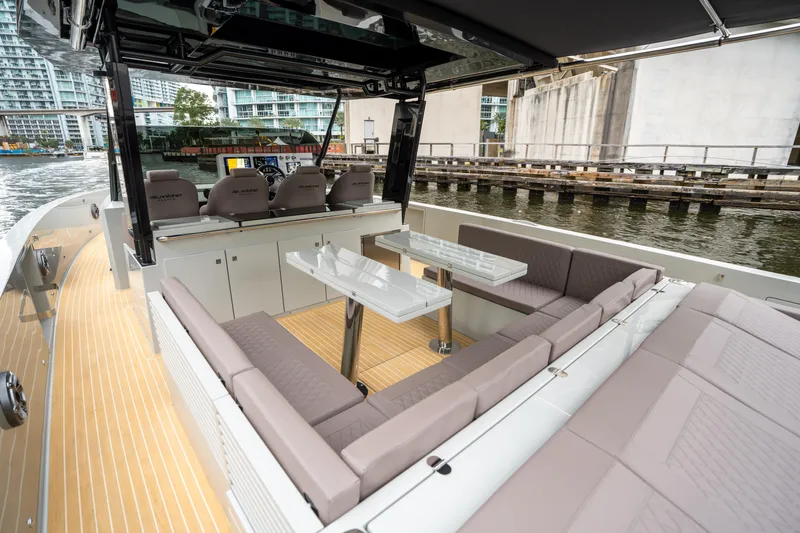  Yacht Photos Pics 2025 De Antonio Yachts D42 Open, luxurious deck seating and dining area by the water.