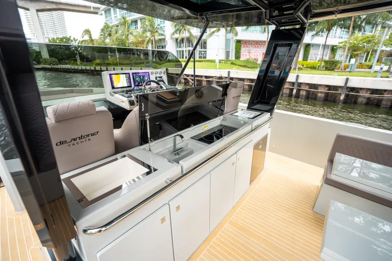  Yacht Photos Pics 2025 De Antonio Yachts D42 Open interior with modern helm and sleek kitchen area.