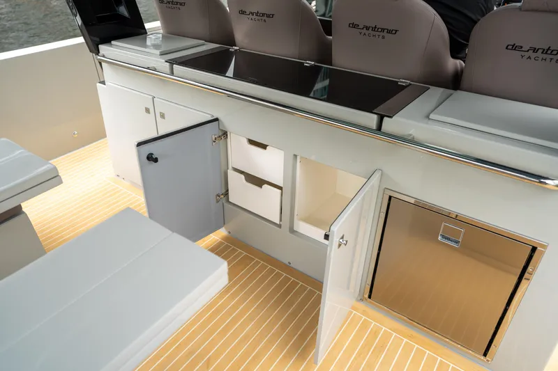  Yacht Photos Pics 2025 De Antonio Yachts D42 Open interior with open storage compartments and sleek design.