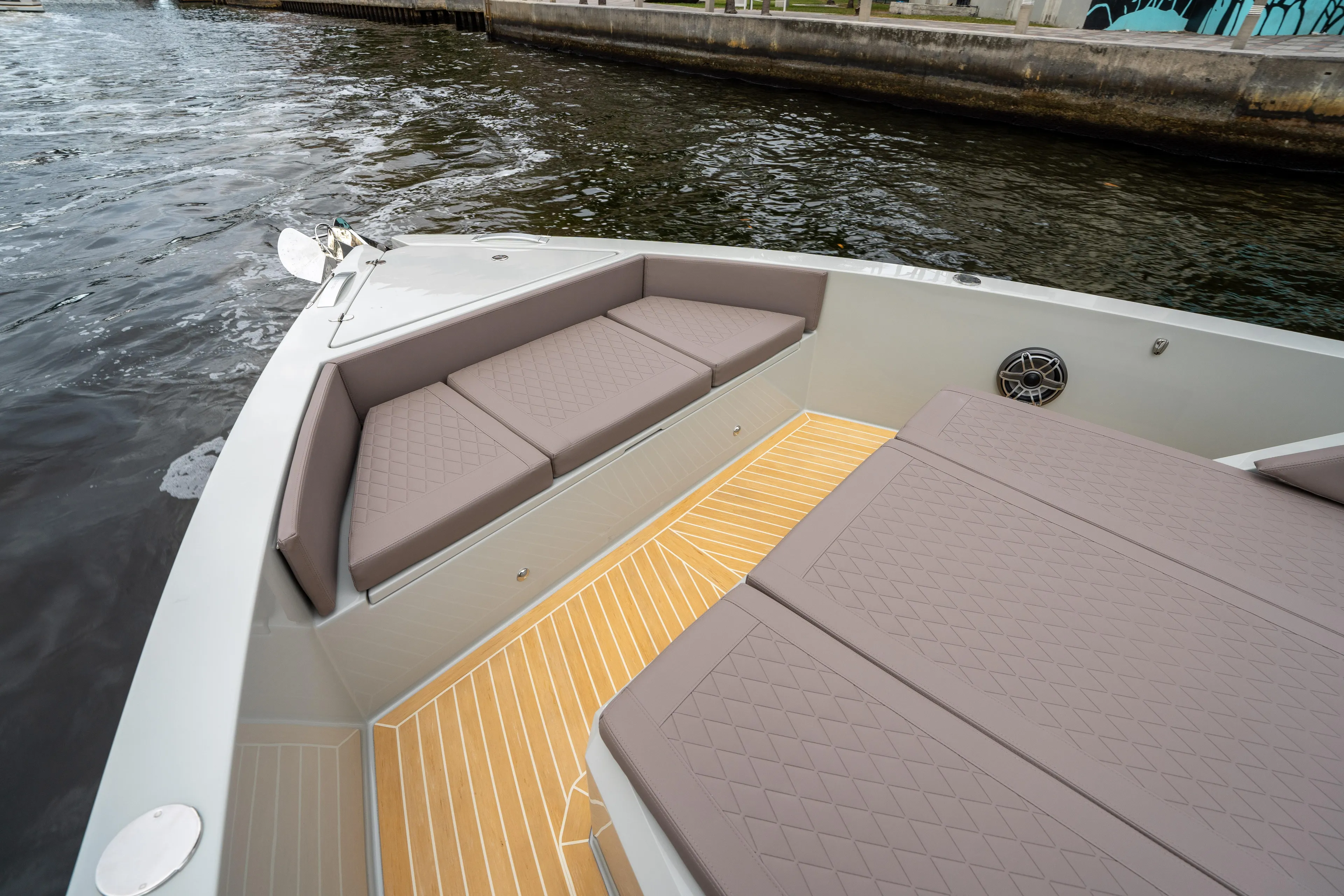  Yacht Photos Pics 2025 De Antonio Yachts D42 Open with cushioned seating and teak deck on calm water.