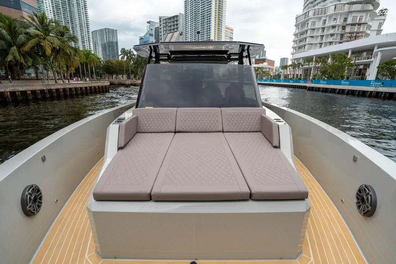  Yacht Photos Pics 2025 De Antonio Yachts D42 Open with spacious deck and luxurious seating in urban marina.
