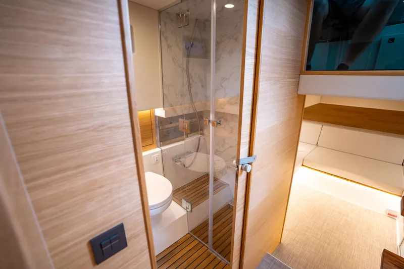  Yacht Photos Pics Luxurious bathroom interior of 2025 De Antonio Yachts D42 Open, featuring modern design and wood accents.