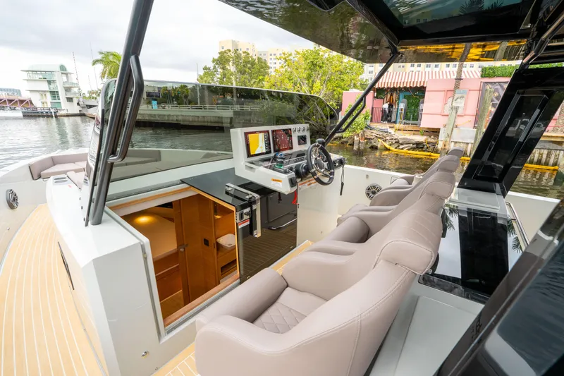  Yacht Photos Pics 2025 De Antonio Yachts D42 Open cockpit with modern helm, luxurious seating, and cabin access.