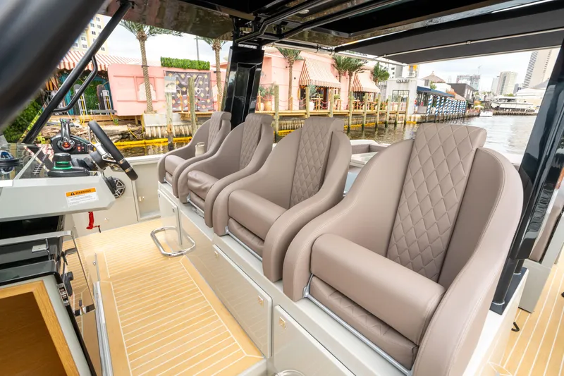  Yacht Photos Pics 2025 De Antonio Yachts D42 Open luxury seating with quilted design, dockside view.