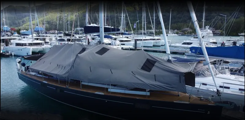  Yacht Photos Pics 2015 Beneteau Sense 55 yacht covered at marina, surrounded by other boats.