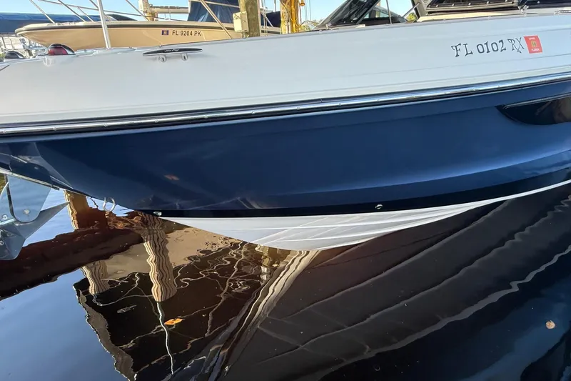 Manda Rae Too Yacht Photos Pics 2018 Sae Ray 38SLV OB boat docked, reflecting on calm water.