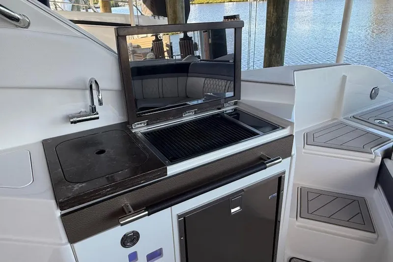 Manda Rae Too Yacht Photos Pics Outdoor kitchen on 2018 Sae Ray 38SLV OB yacht with grill and sink by the water.