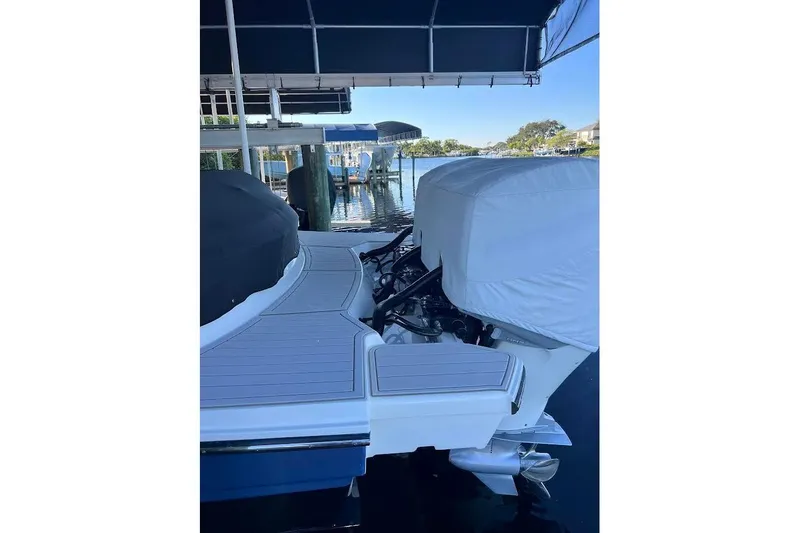 Manda Rae Too Yacht Photos Pics 2018 Sae Ray 38SLV OB boat docked under a canopy, rear view.