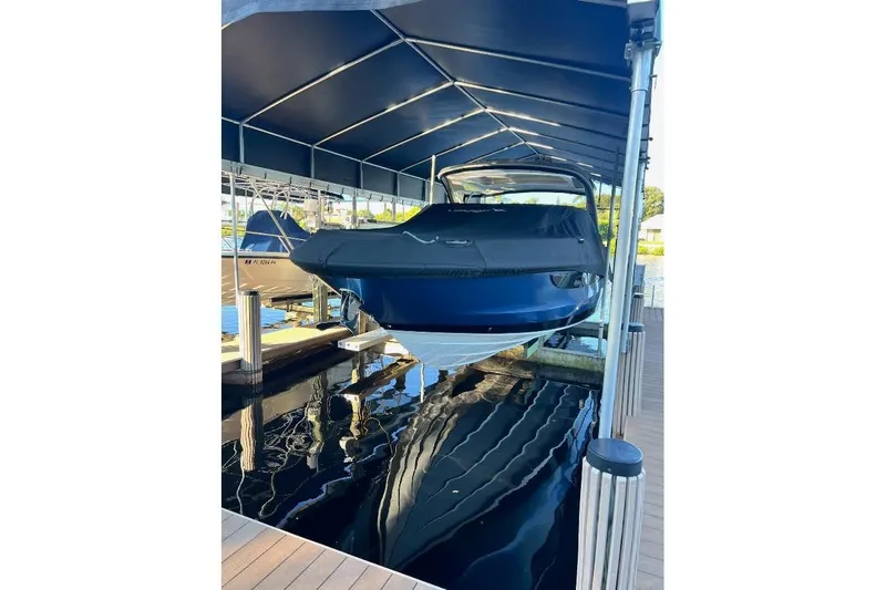 Manda Rae Too Yacht Photos Pics 2018 Sae Ray 38SLV OB boat docked under a covered marina.
