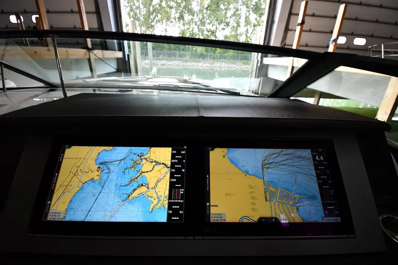  Yacht Photos Pics Dashboard of 2020 Sea Ray SLX 400 Outboard with navigation screens in a marina setting.