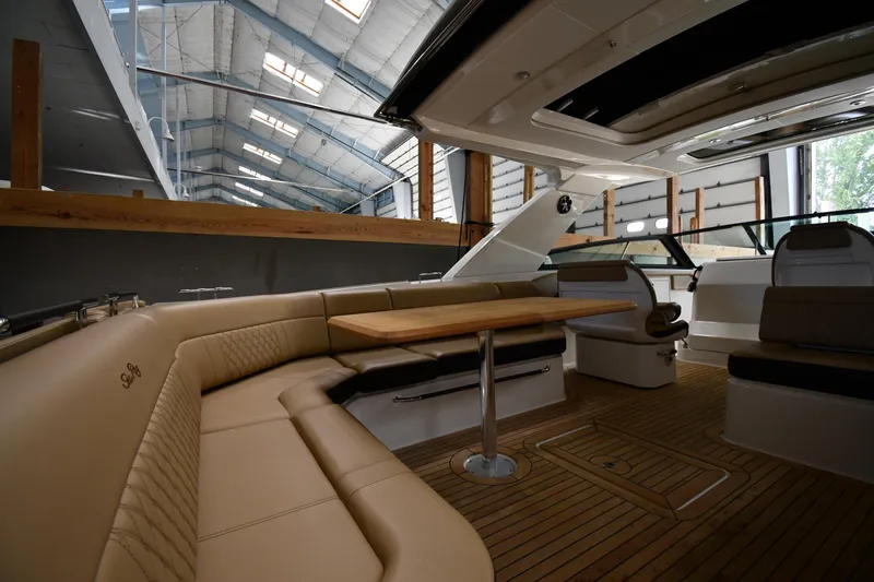 Yacht Photos Pics 2020 Sea Ray SLX 400 Outboard interior with luxurious seating and wooden table.