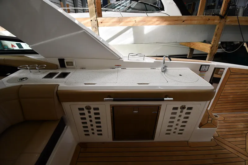  Yacht Photos Pics 2020 Sea Ray SLX 400 Outboard boat interior with kitchenette and wooden flooring.