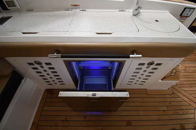  Yacht Photos Pics 2020 Sea Ray SLX 400 Outboard boat interior with open drawer and blue lighting.