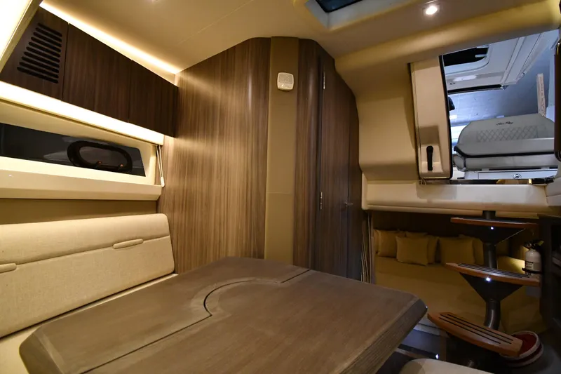  Yacht Photos Pics Luxurious interior of 2020 Sea Ray SLX 400 Outboard, featuring elegant wood finishes and seating.