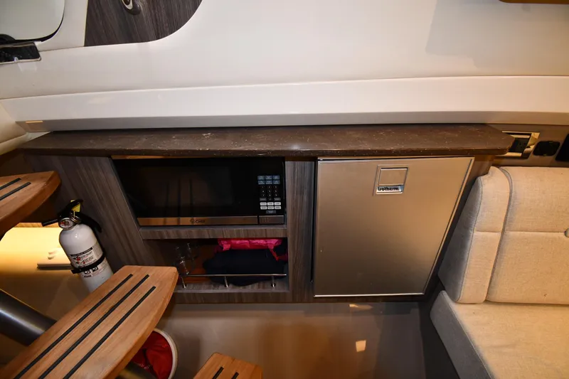  Yacht Photos Pics 2020 Sea Ray SLX 400 Outboard interior with microwave, fridge, and seating area.