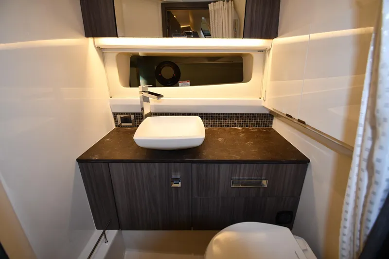  Yacht Photos Pics Luxurious bathroom interior of 2020 Sea Ray SLX 400 Outboard yacht, featuring modern sink and cabinetry.