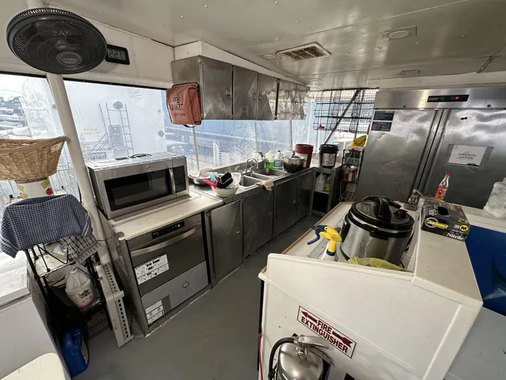 93' Dive Boat Yacht Photos Pics Interior of a 1965 custom dive boat kitchen with appliances and storage.
