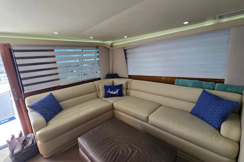 Covert Mission Yacht Photos Pics Luxurious interior of a 1998 Viking 58 Convertible yacht with plush seating and decorative pillows.