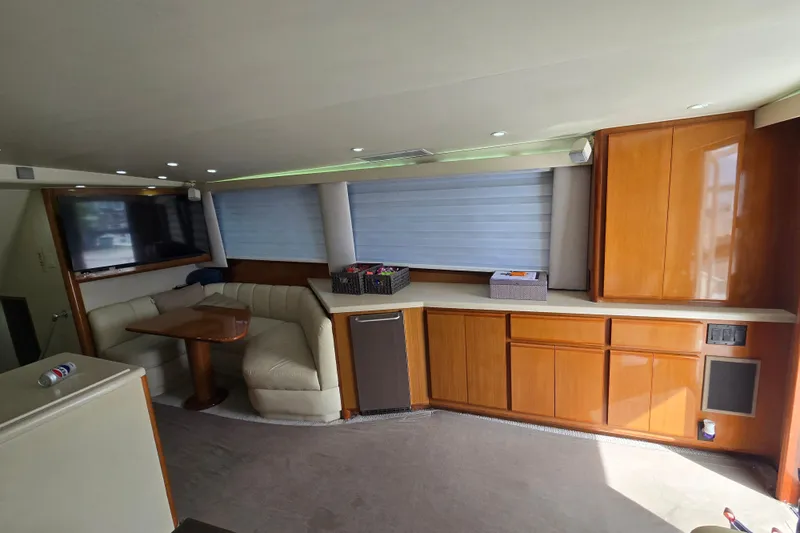 Covert Mission Yacht Photos Pics Interior of salon with seating, dinette table, and cabinetry.