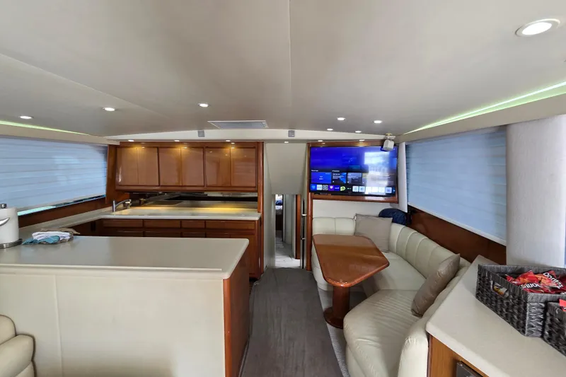 Covert Mission Yacht Photos Pics Luxurious and spacious interior of a 1998 Viking 58 Convertible yacht with modern amenities and cozy seating.